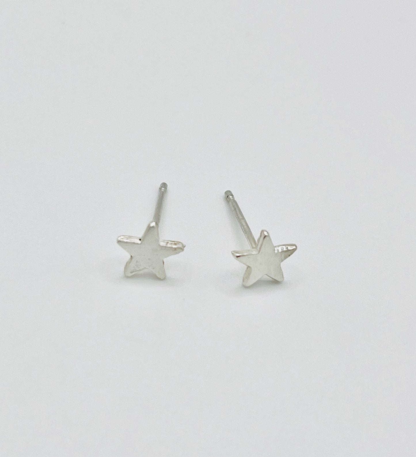 Silver star studs.