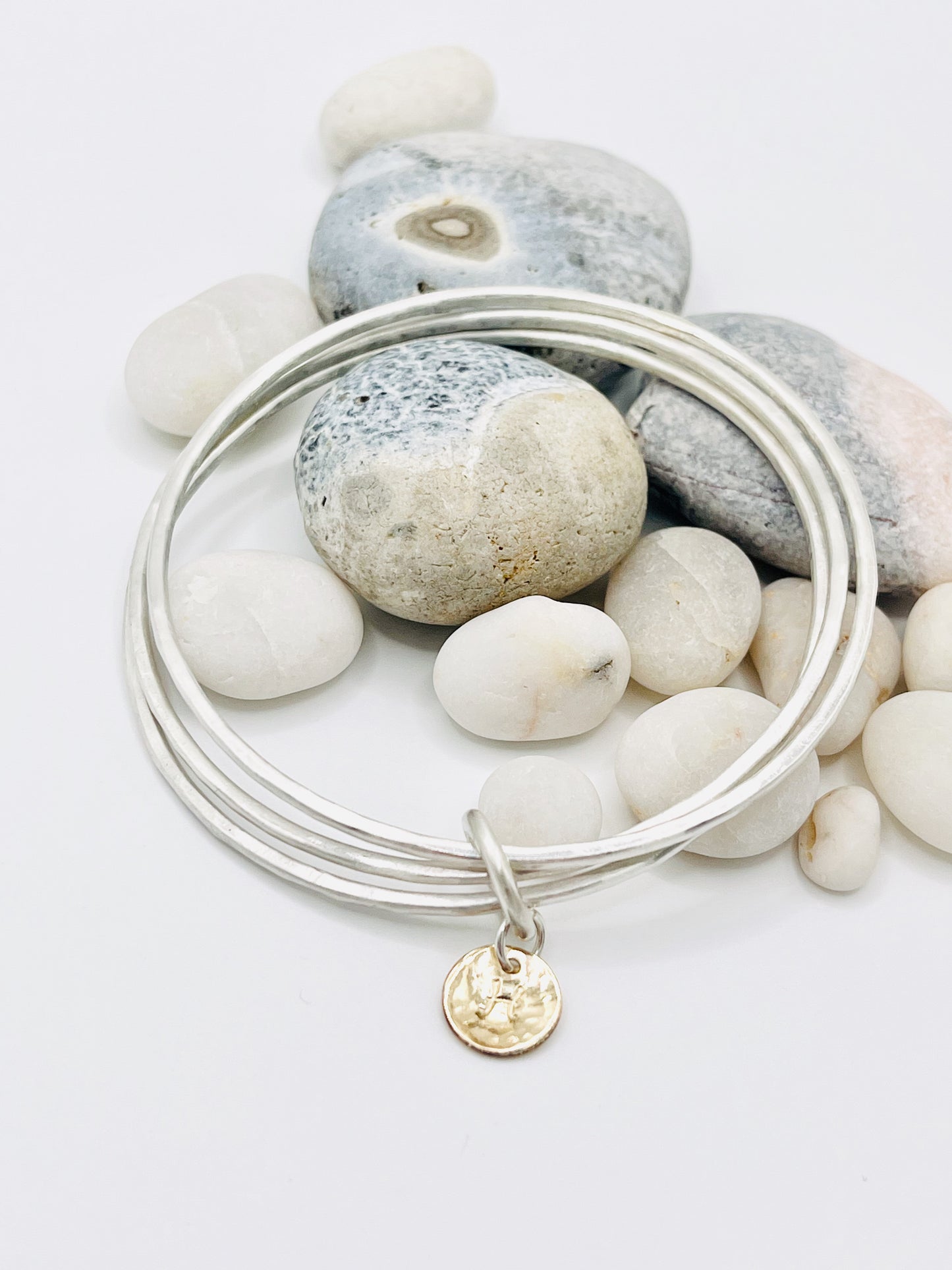 Triple stacking bangle with gold disc.