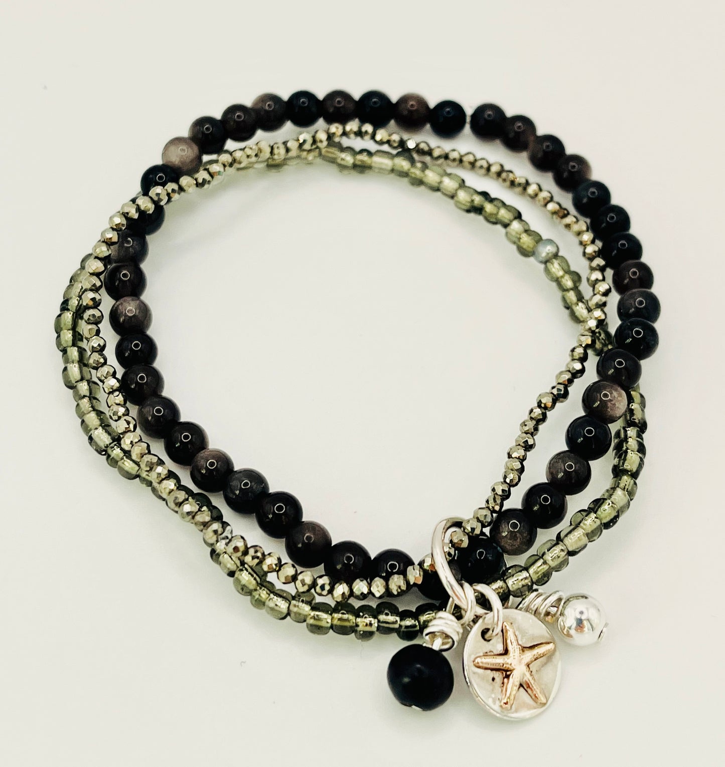 Gold starfish stacking bracelet.