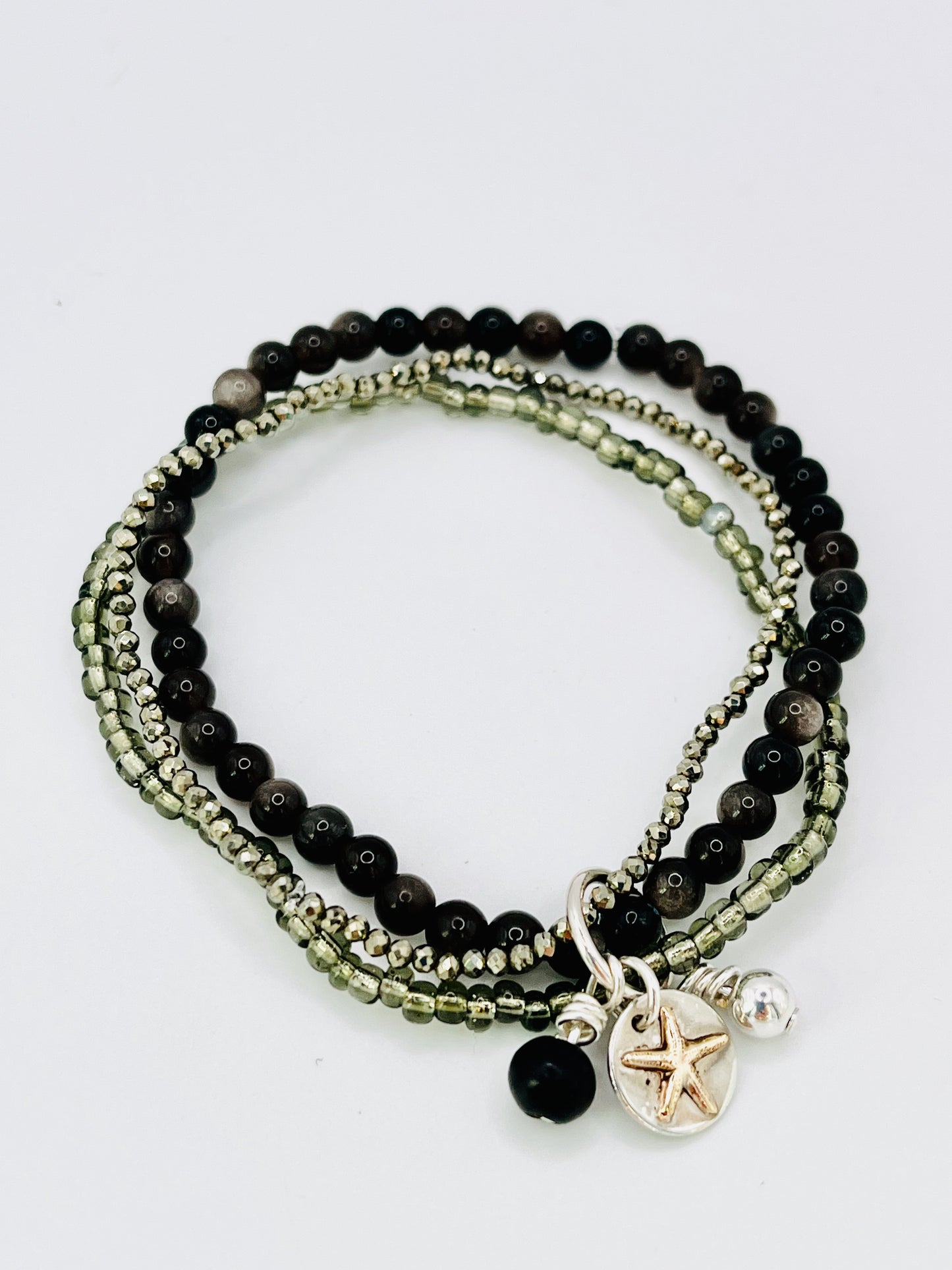 Gold starfish stacking bracelet.