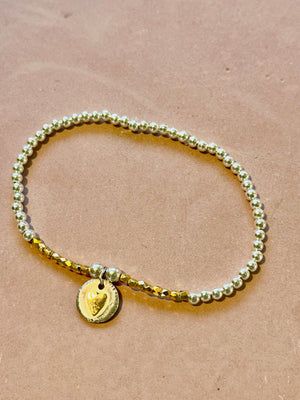 Gold heart beaded bracelet.