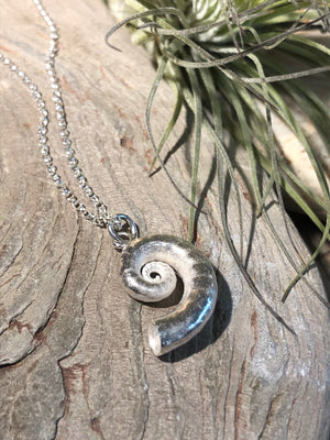 Chunky silver spiral shell necklace.