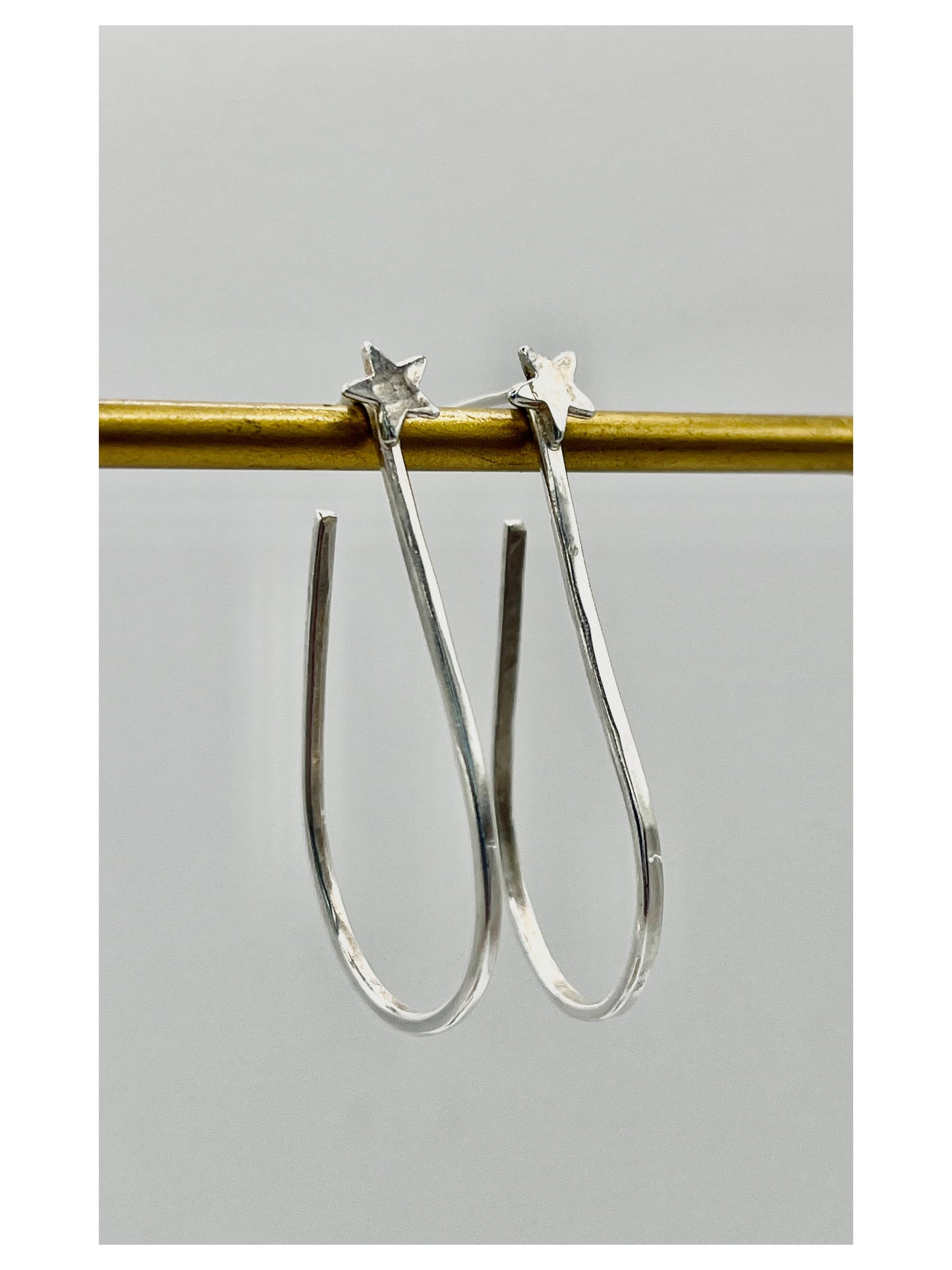 Silver star hoops.