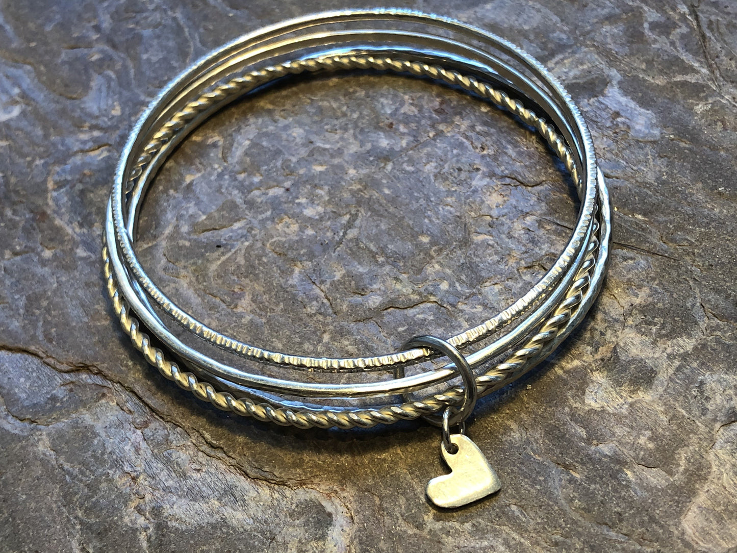 Multi textured bangle stack with personalised disc or heart.