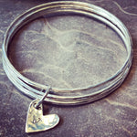 Silver triple linked bangle with personalised heart charm.