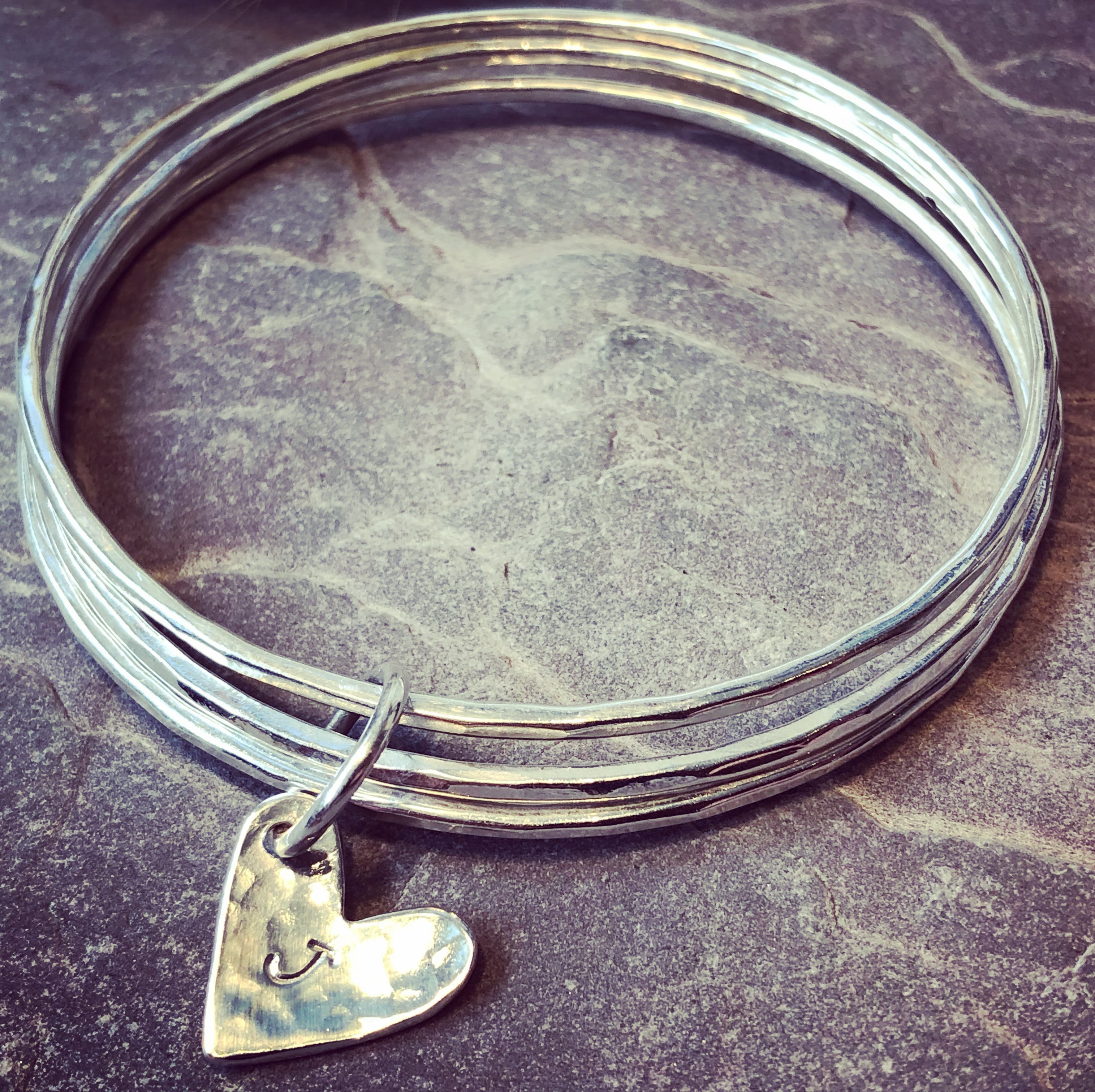 A trio of textured silver bangles.