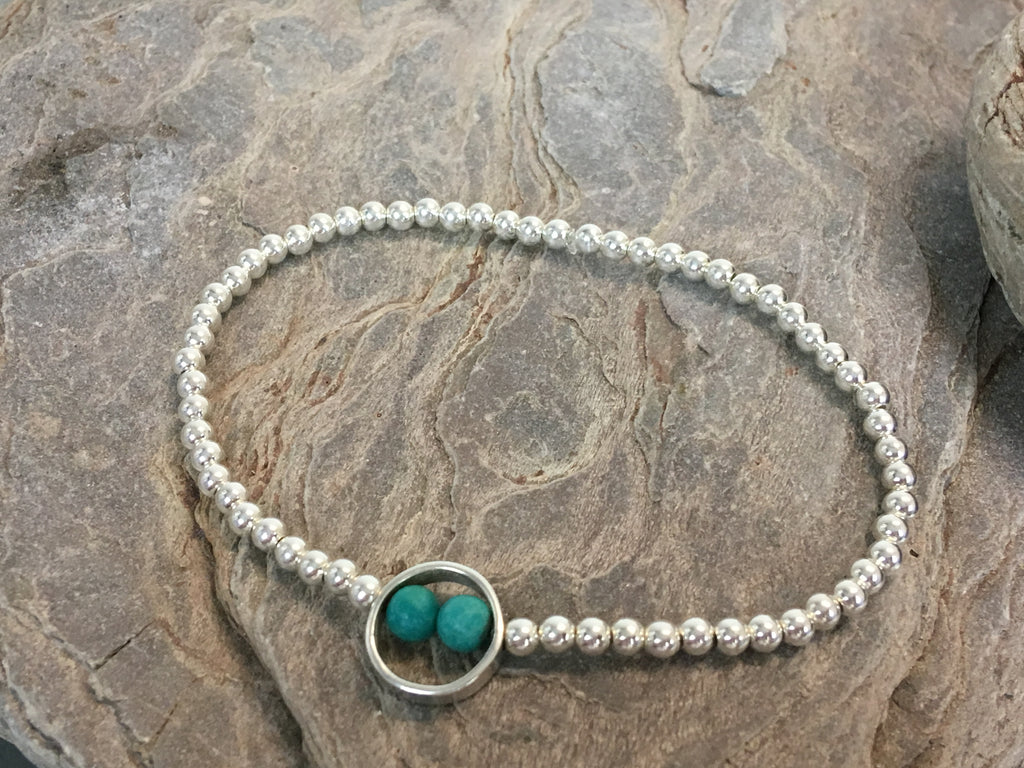 Silver bead bracelet with double aqua bead