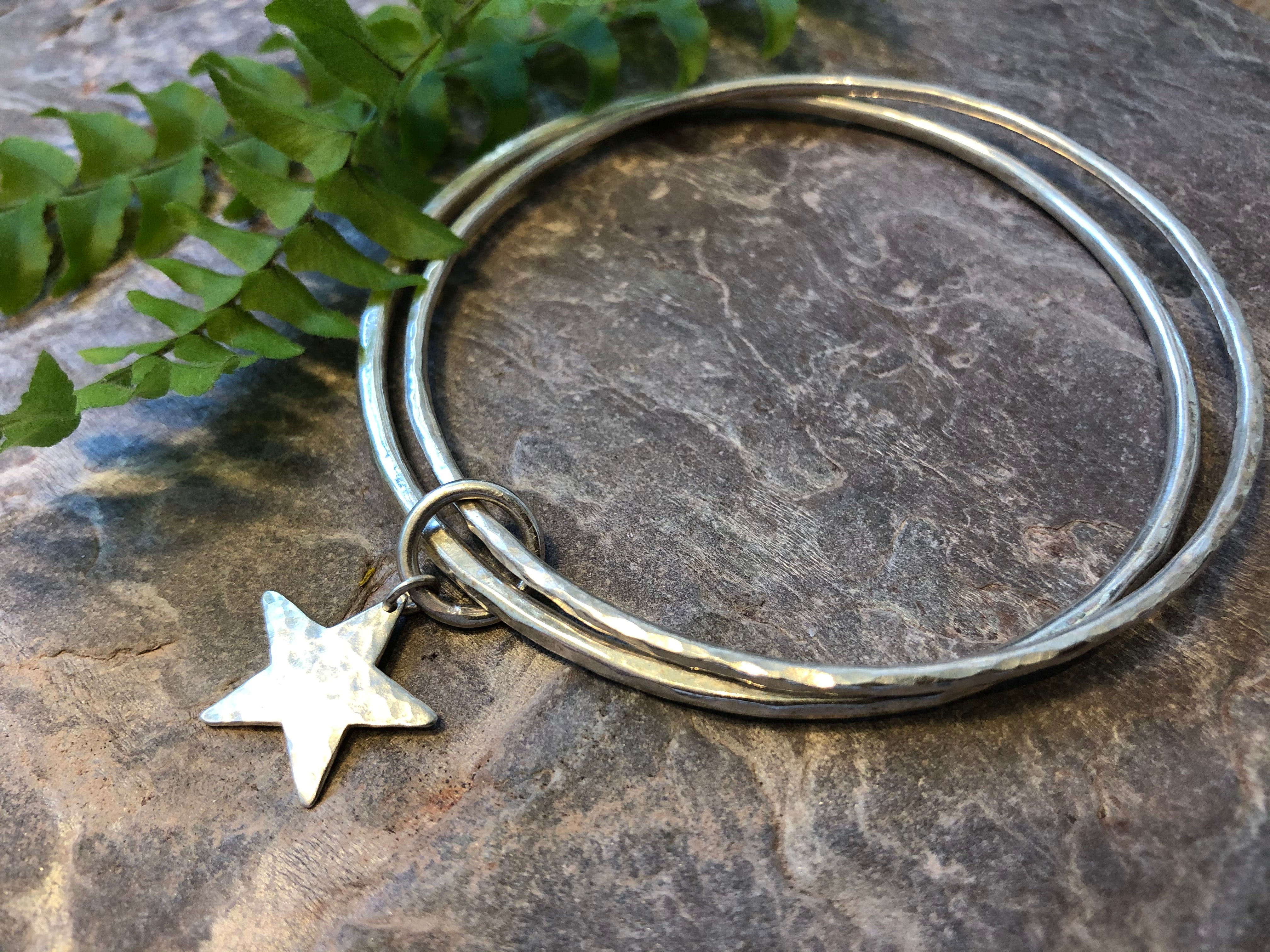 Double silver bangle with joining star.