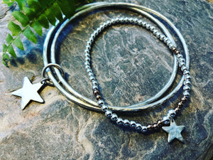 Double silver bangle with joining star.