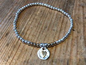 Silver Beaded bracelet with gold heart.