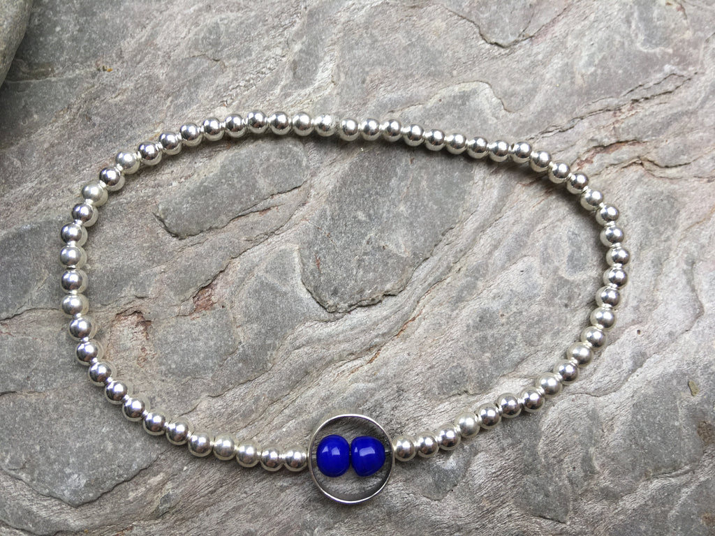 Silver beaded bracelet with double blue stone