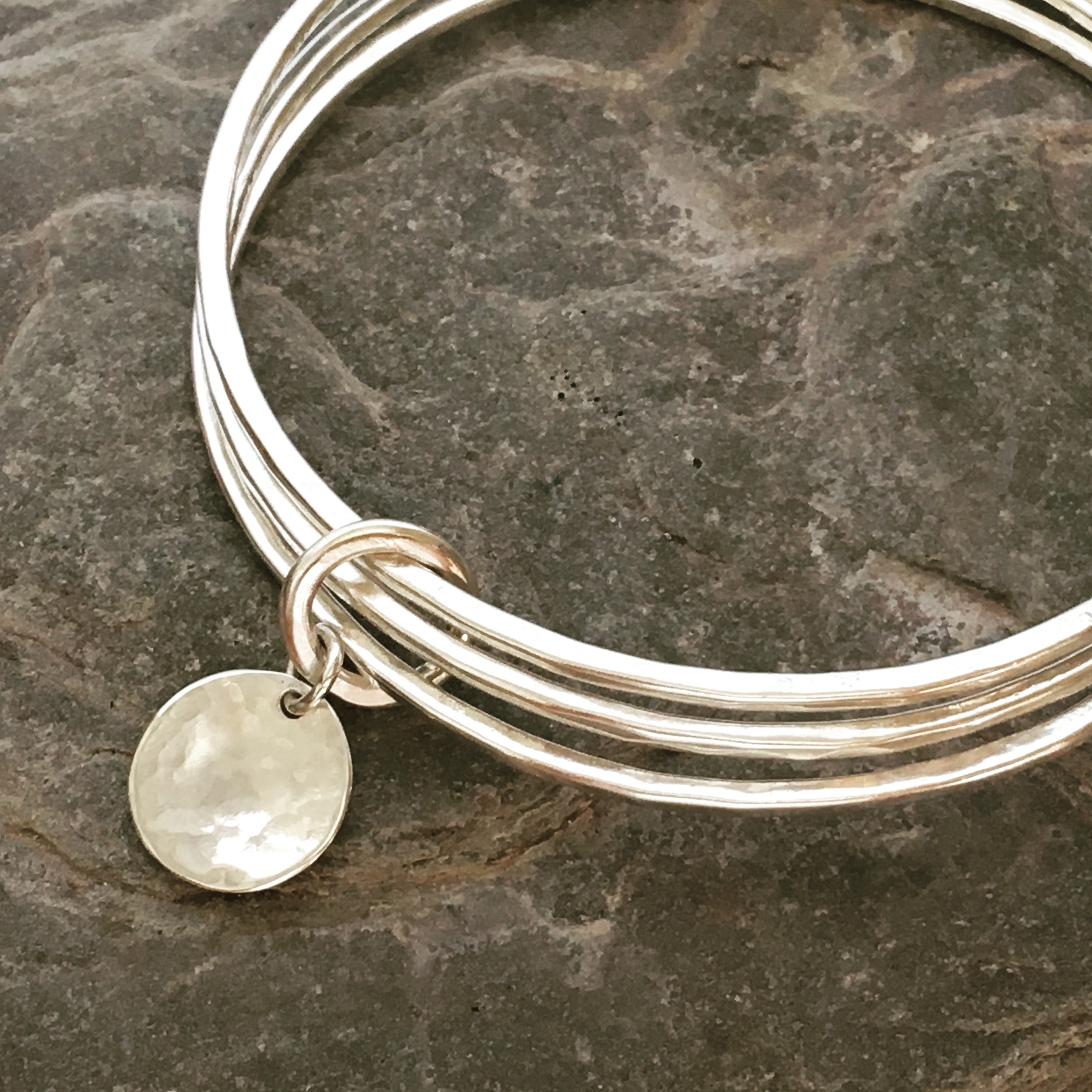 A trio of textured silver bangles.