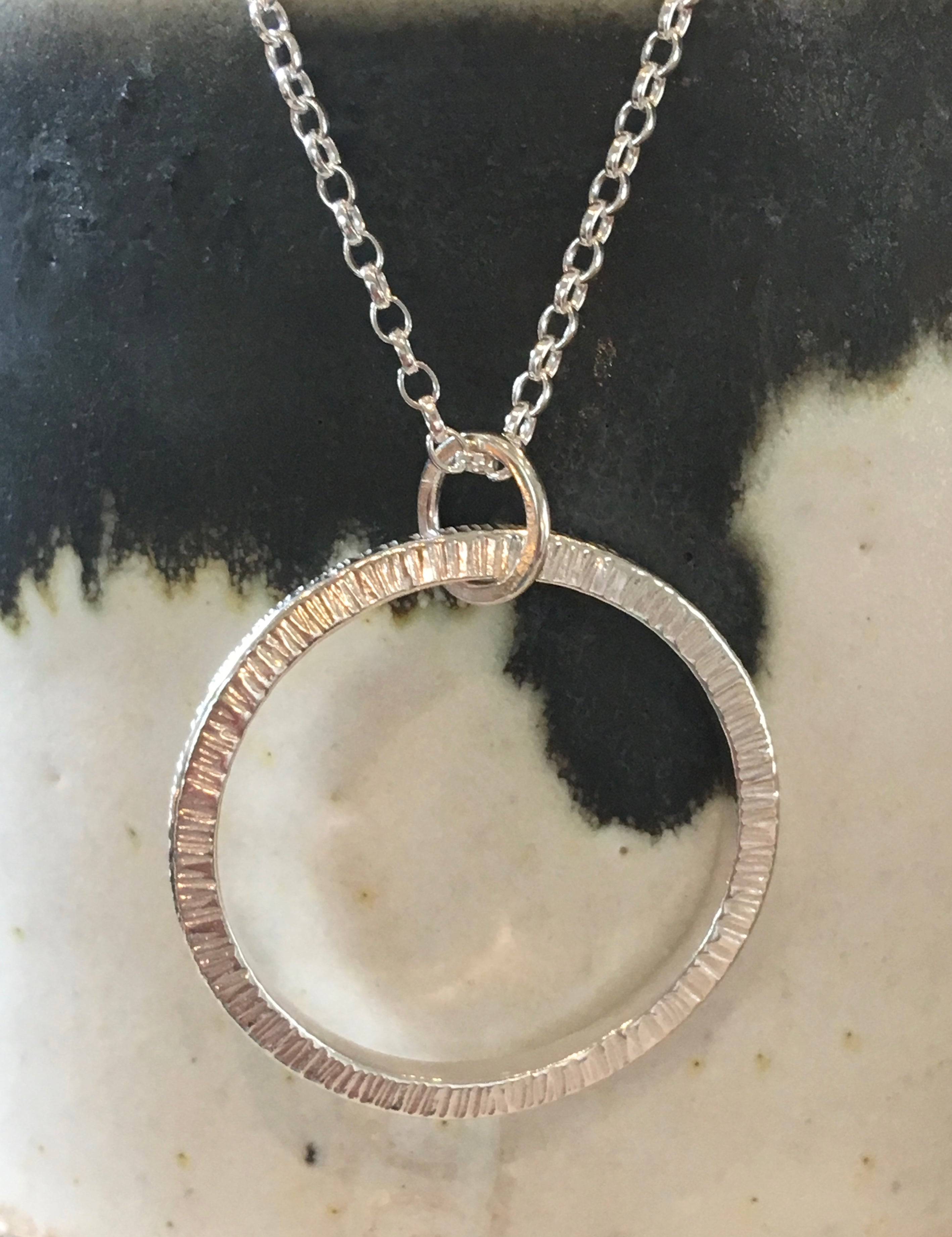 Driftwood pattern, silver circular necklace.