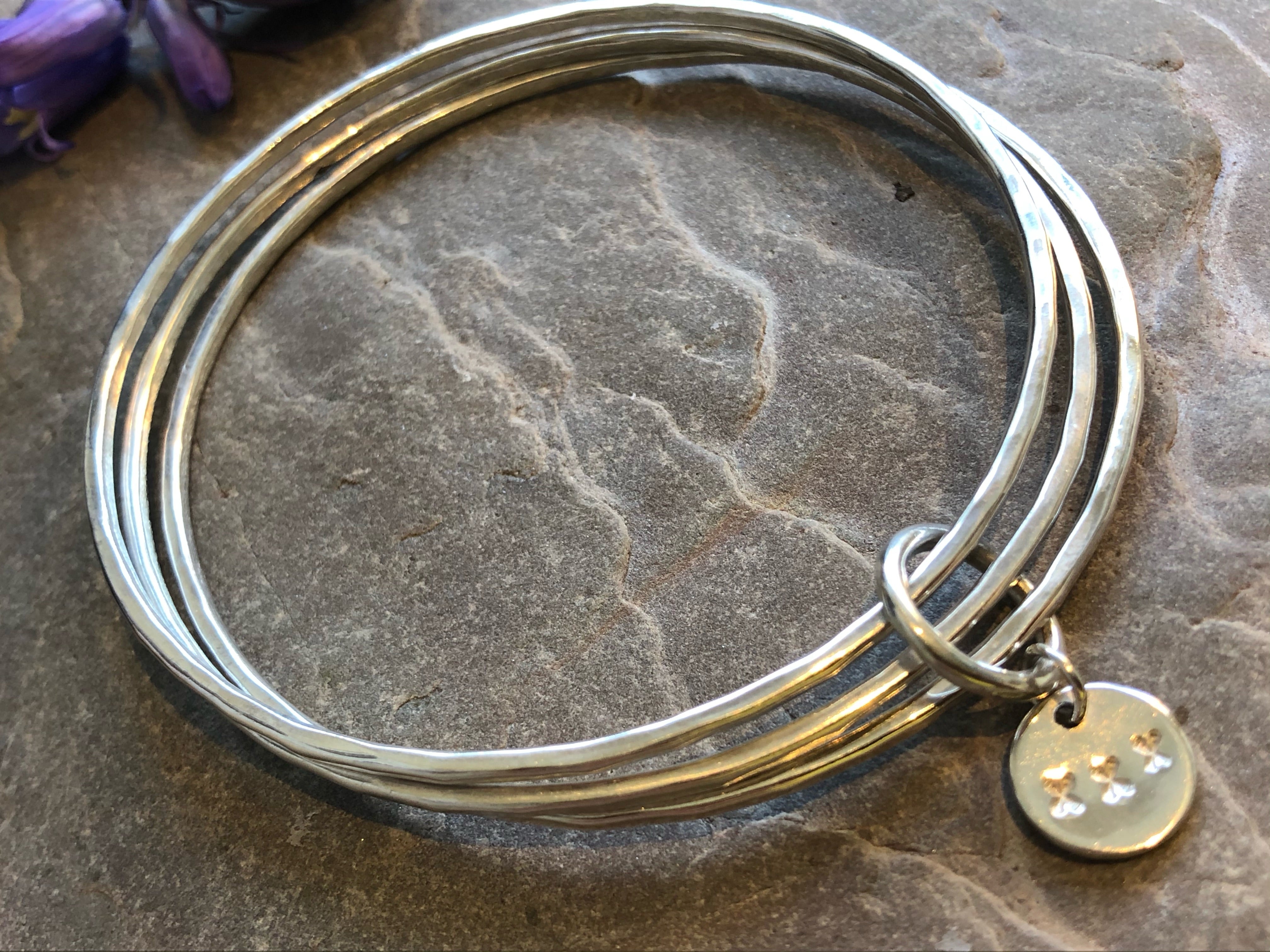 A trio of textured silver bangles.