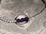 A beaded silver bracelet with silver ring and Amethsyt stone.