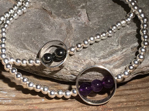 A beaded silver bracelet with silver ring and Amethsyt stone.