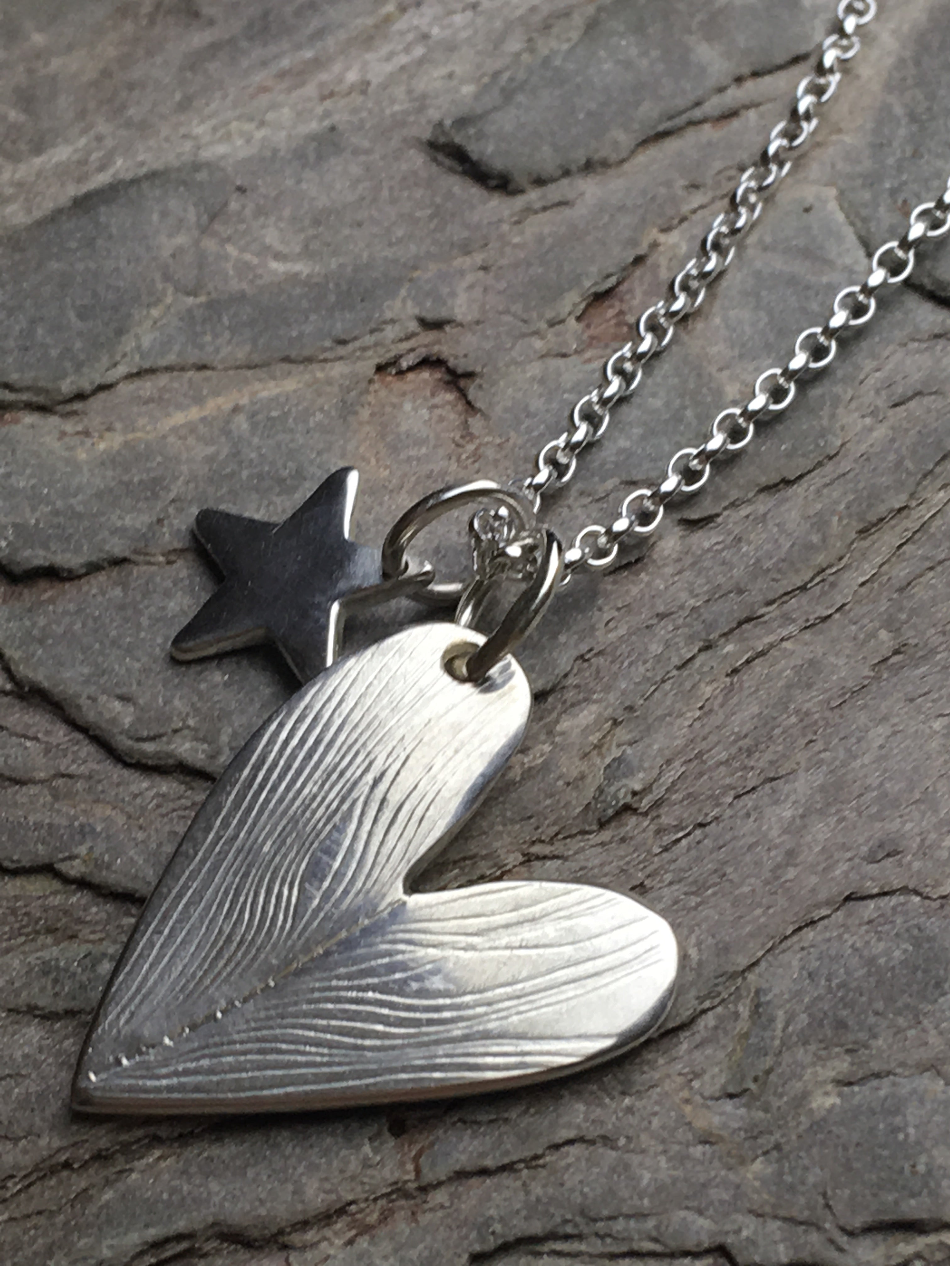 Silver heart with star necklace.