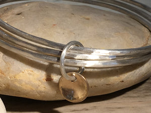 Brushed silver triple bangle.