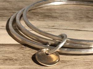 Brushed silver triple bangle.