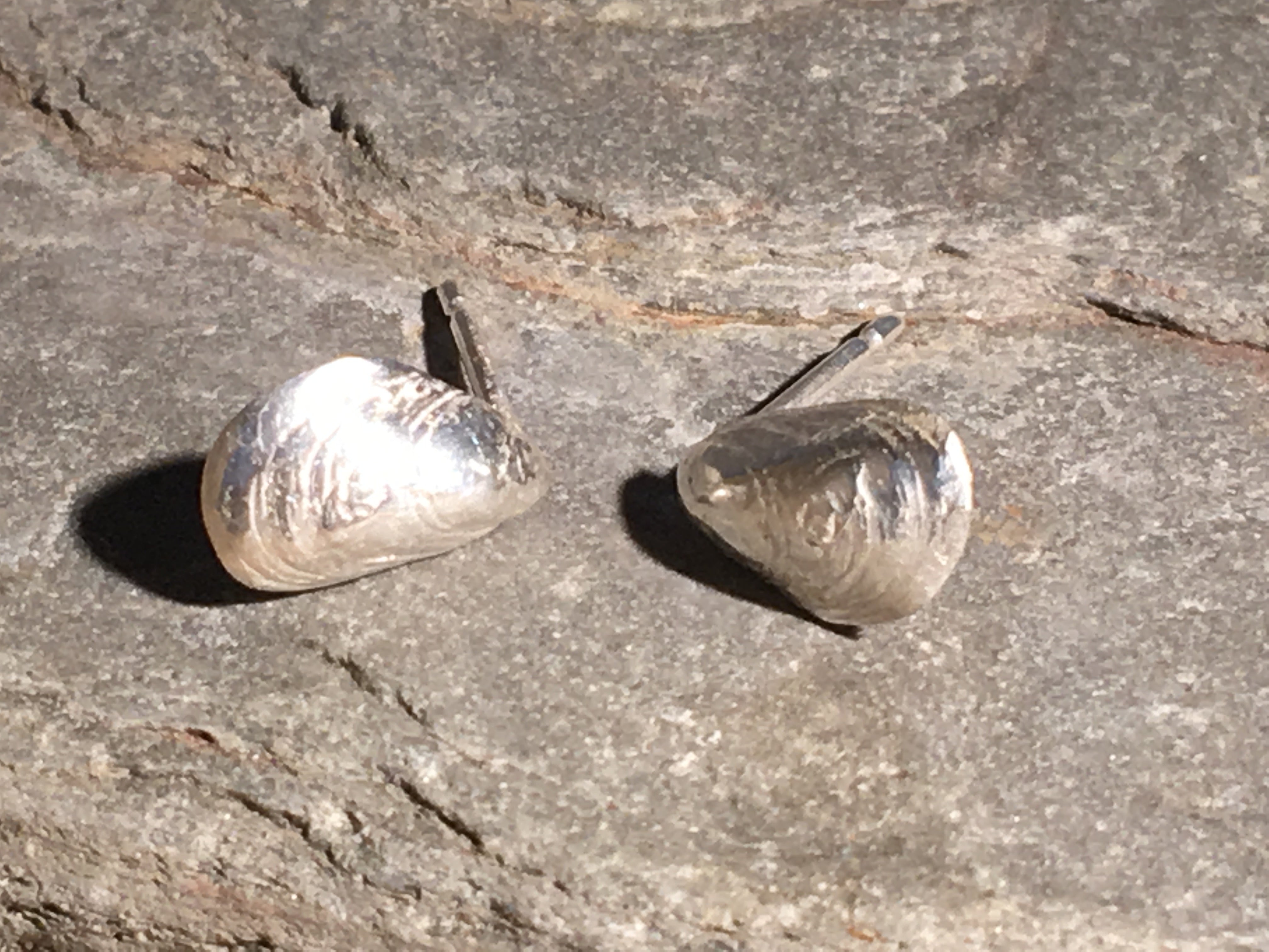 Silver mussel shell studs.