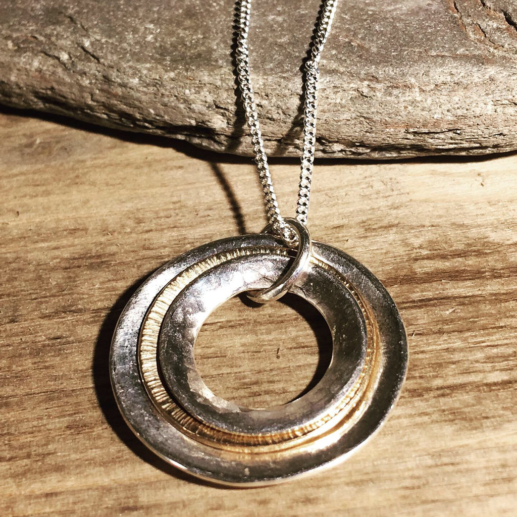 Silver and gold multi textured domed rings necklace.