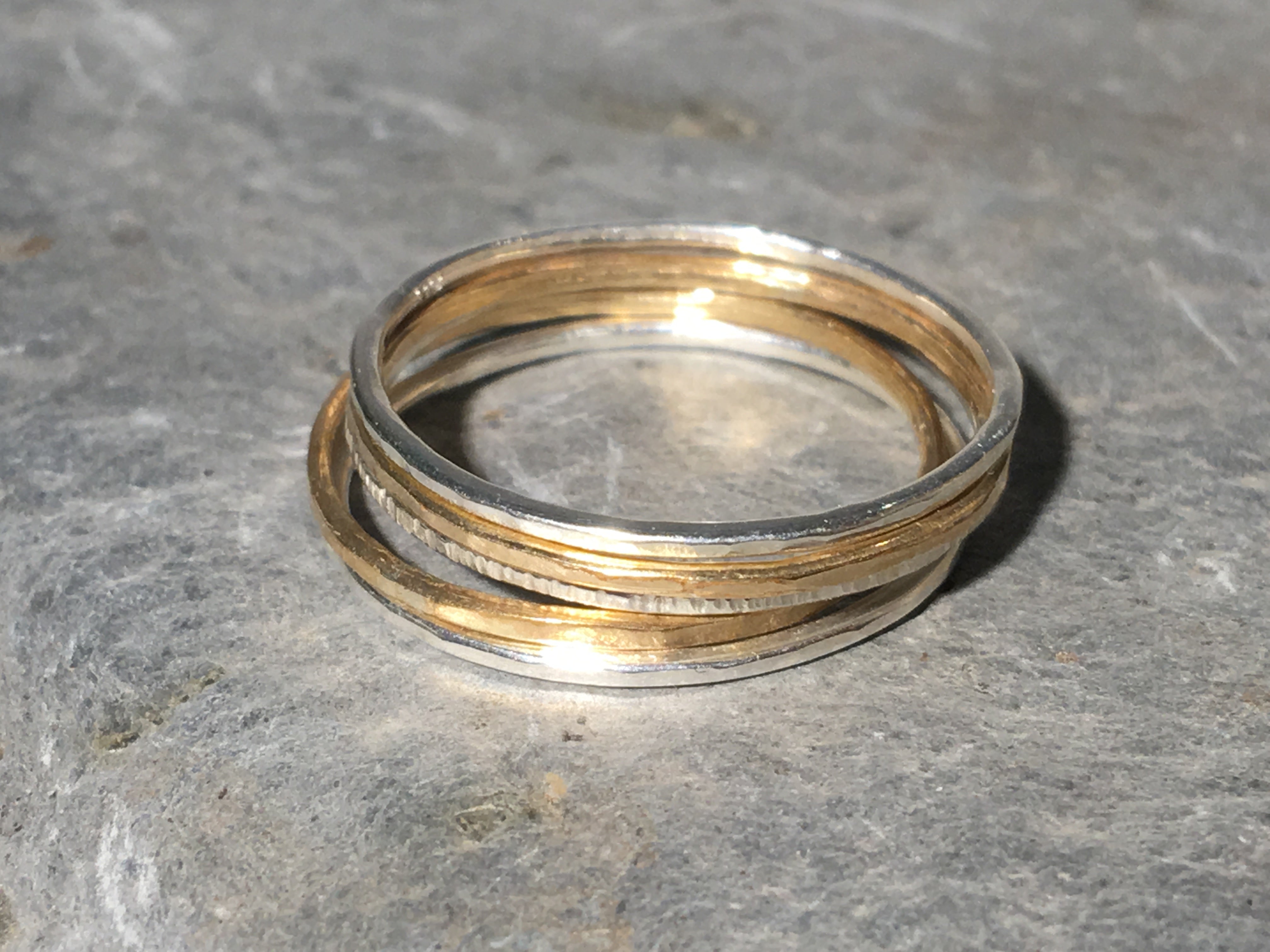 A set of silver and gold stacking rings.