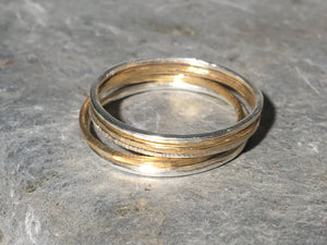 A set of silver and gold stacking rings.