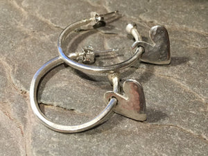 Silver hoops with hanging hearts.