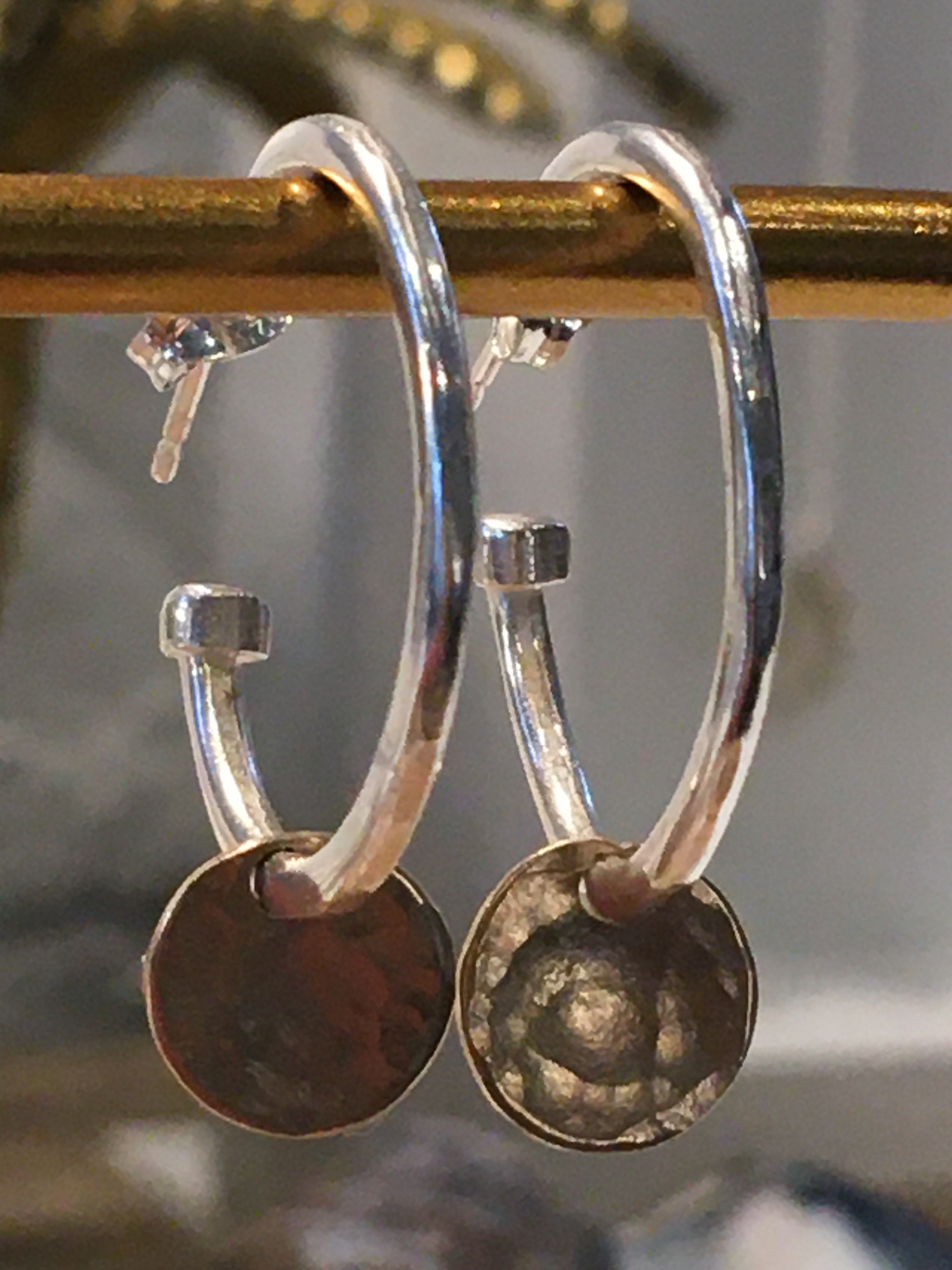 Silver hoop earings with gold disc.