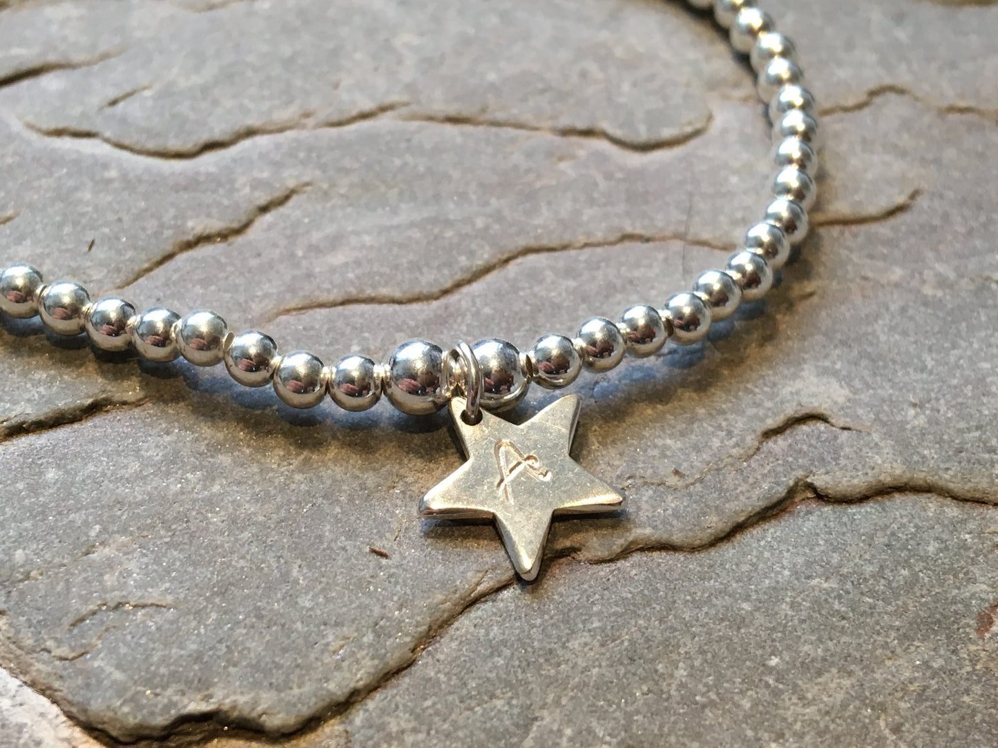 Silver beaded bracelet with silver star.