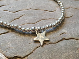 Silver beaded bracelet with personalised silver star.