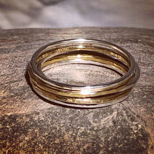A set of silver and gold stacking rings.