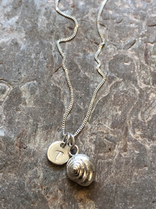 Silver personalised shell necklace.